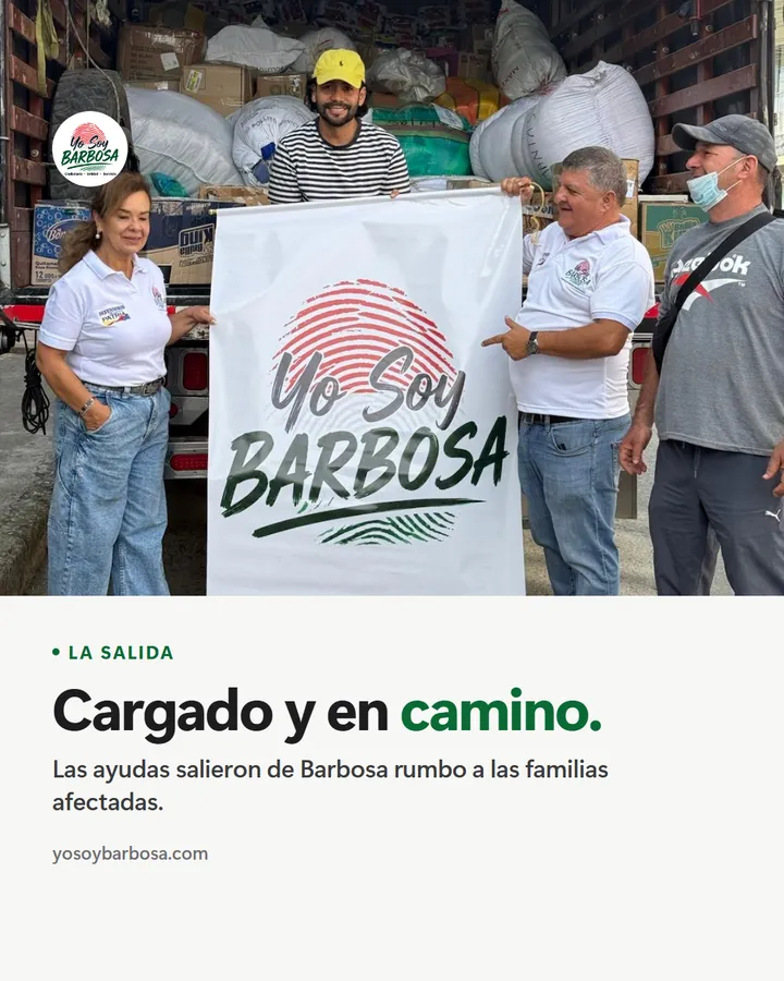 Cargado y en camino. Integrantes de Yo Soy Barbosa sostienen el pendón del movimiento frente a un camión cargado de ayudas.